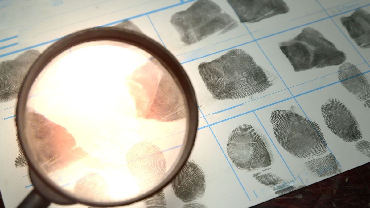 Crime and violence concept.Magnifying glass hold on  fingerprinting charlotte NC